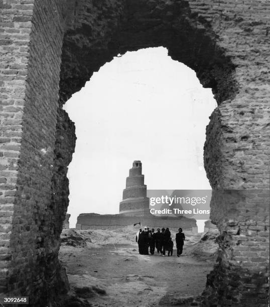 Circular stepped tower seen through a broken archway is said to be similar in appearance to the Tower of Babel and located in the same area.