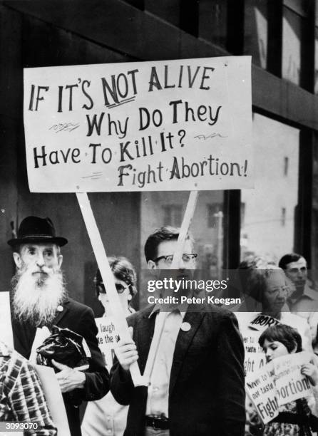 An anti-abortion protestor at a demonstration in front of the American Hotel in mid-town New York, where the American Medical Association is holding...