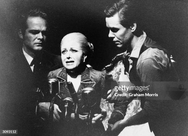 An aged Eva Peron, played by Elaine Paige, being helped to a microphone to make her last speech, in the musical 'Evita', by Andrew Lloyd-Webber and...