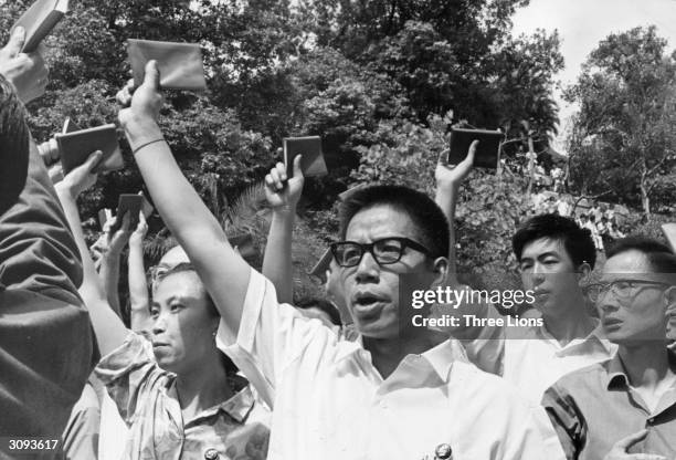 Mob outside Government House in China shouts communist slogans and waves copies of Mao Tse-Tung's 'little red book' entitled 'The Thoughts of...