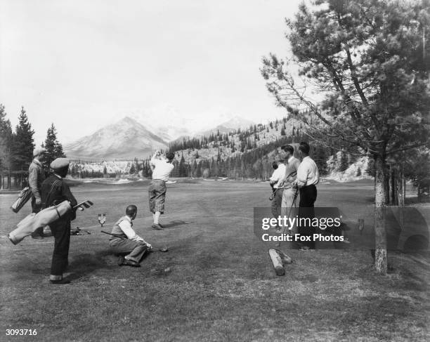 Group of men playing golf on Banff Springs golf course.