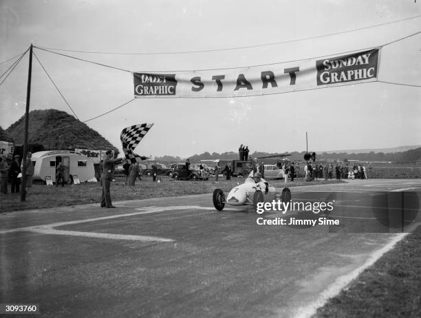 British motor-racing driver Stirling Moss winning the race for midget racing cars on the Goodwood Estate in a Cooper car.