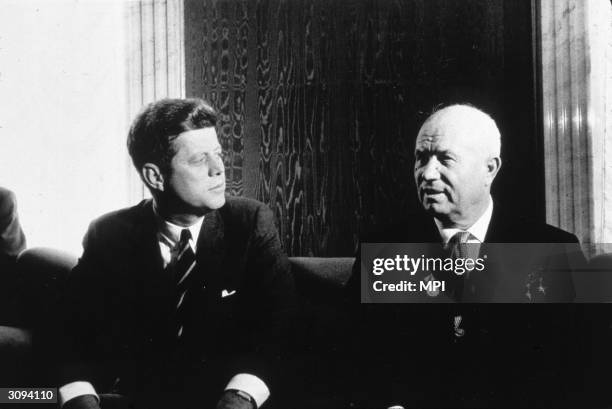 President John Kennedy talks with Russian Soviet leader, Nikita Khrushchev .