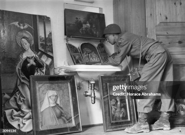 American servicemen view art treasures on show at a former Luftwaffe barracks near Konigsee. Priceless paintings looted from all parts of Europe...