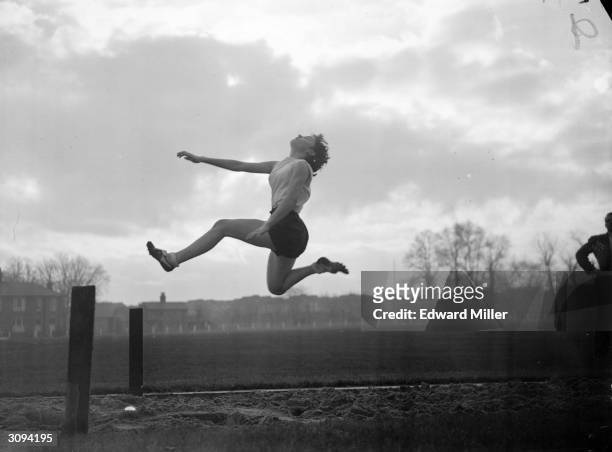Valerie Webster of Great Britain in action during long-jump training at Motspur Park for the 1952 Helsinki Olympics.