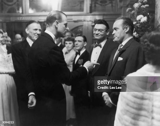 Prince Philip, Duke of Edinburgh, stresses a point to US comedian Bob Hope at a party after the Royal Variety Show at the London Palladium. Frankie...