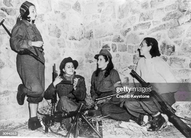 Quartet of Italian anti-Fascist women patriots who are helping the Allied forces on the Castelluccio front, are shown relaxing while awaiting orders...