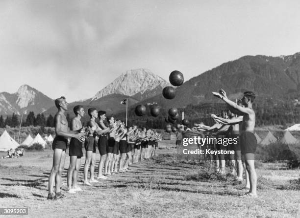 Hitler youths playing with medicine balls at the Wilhelm Gustloff Camp on the edge of the Faaker Lake in Austria.