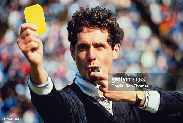 football referee blowing whistle & holding up yellow card (composite) - referee card stock pictures, royalty-free photos & images