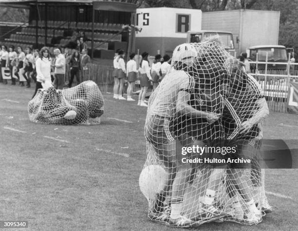 Contestants from Hounslow and Kingston getting tangled in a net while filming the first central London episode of the television show 'Its A...