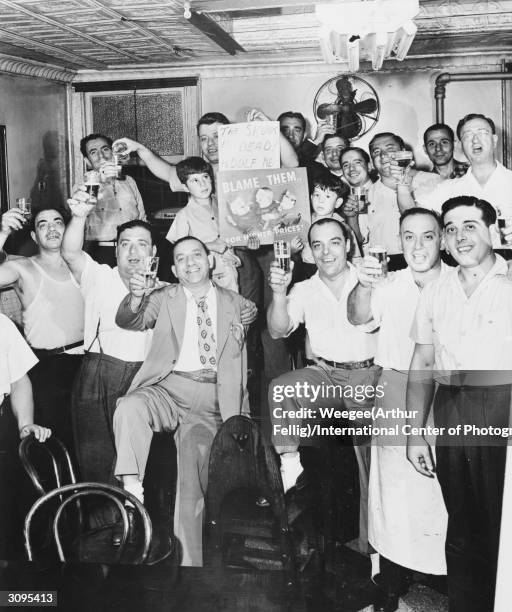 The patrons of an American bar raise their glasses in celebration at the death of Adolf Hitler.