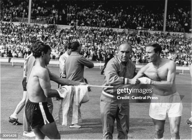 England football manager Alf Ramsey preventing George Cohen swapping his shirt with an Argentinian player after a bad tempered World Cup...