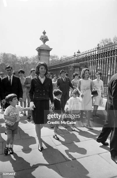 Jackie Kennedy, widow of president John F. Kennedy, outside Buckingham Palace during a visit to London with her son John Jr., her sister Lee...