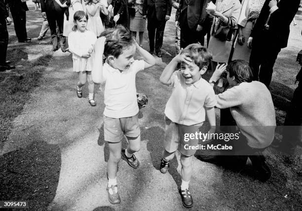John F. Kennedy Jr. , the son of Jackie Kennedy and the late American president walking in Green Park, London with his cousins Anthony and Tina , the...
