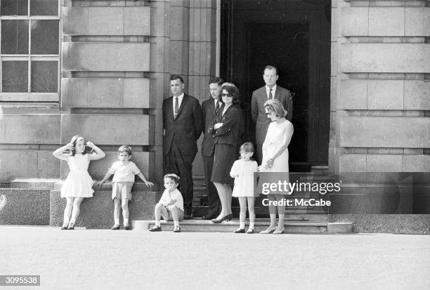 Jackie Kennedy, widow of John F. Kennedy watching the changing of the guard at Buckingham Palace, London, with her children John Jr. And Caroline,...