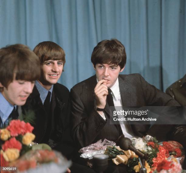 George Harrison , Paul McCartney and Ringo Starr of the Liverpudlian pop group The Beatles at a press conference in London Airport following a tour...