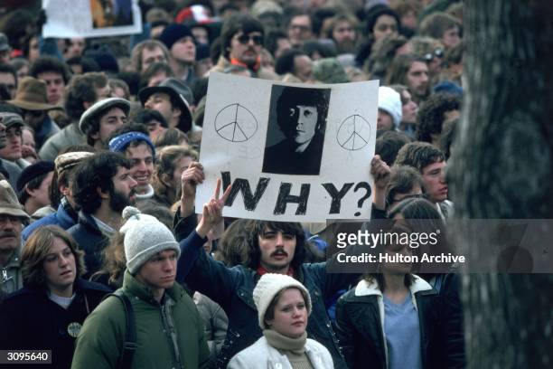 Fans of John Lennon holding a vigil after he was shot dead by a fan on December 8th at his home in New York.