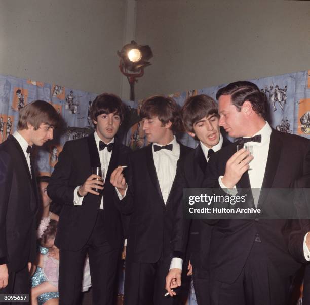George Harrison , John Lennon , Paul McCartney and Ringo Starr of the Liverpudlian pop group The Beatles with their manager Brian Epstein at the...