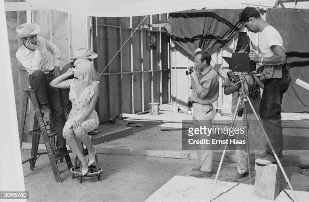 Magnum photographers Bruce Davidson and Elliott Erwitt set up a shot of Marilyn Monroe , Clark Gable and Montgomery Clift on the set of 'The...