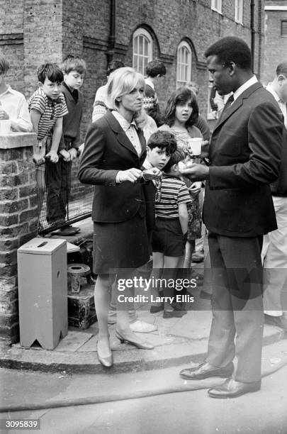 English actress Suzy Kendall with Sidney Poitier on the set of their new film 'To Sir With Love'.