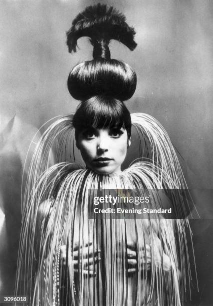 Italian fashion model and actress Elsa Martinelli wearing her hair in a giant topknot.