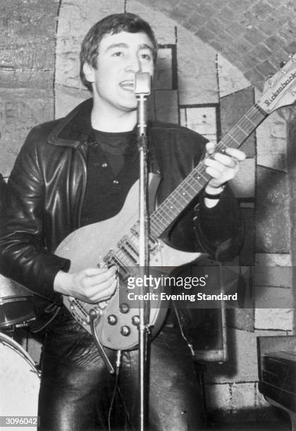 Singer, guitarist and songwriter John Lennon of the British group The Beatles live on stage at the Cavern Club in Matthew Street, Liverpool.