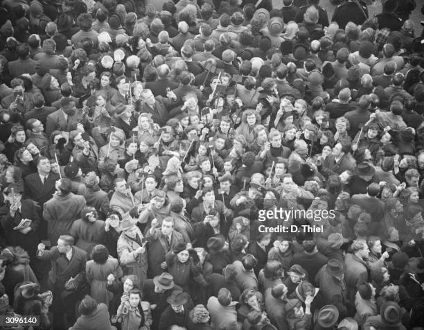 Mourners using periscopes to view the funeral cortege at the funeral of King George VI at Westminster Hall, London, 15th February 1952.