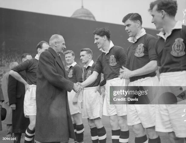 Field Marshal Bernard L. Montgomery shakes hands with Scottish inside right footballer W Anderson, March 17, 1952.