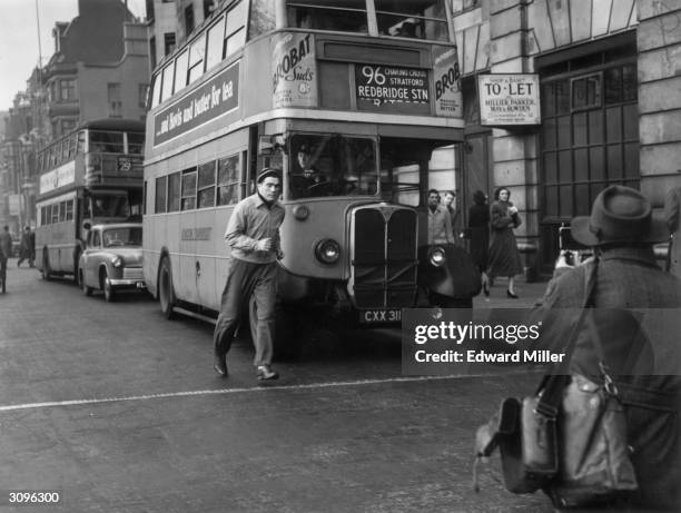 American boxer Joey Maxim jogs through London's Piccadilly, whilst training for his upcoming title fight against light-heavyweight champion Freddie...