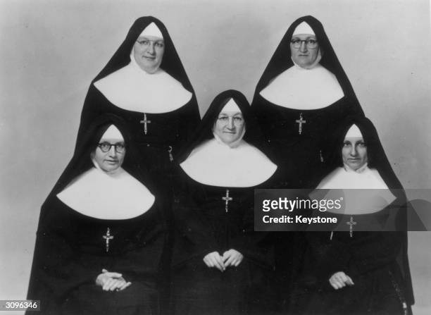 Five nuns who are all sisters. L to r Sister St Denis, Sister Anne of Jesus, Sister Marie Xavier. Standing l to r; Sister Marie Daniel and Sister...