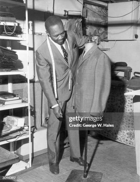 Clifford Fullerton, a recent immigrant from Kingston, Jamaica, working as a tailor in London's Royal Borough of Kensington and Chelsea.