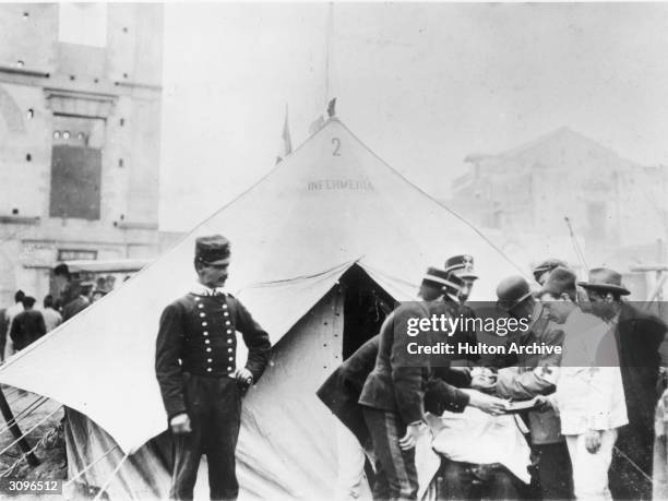 Members of the Italian Red Cross seeing to the injured in Messina, Sicily after an earthquake that destroyed half the town and killed over 77,000...