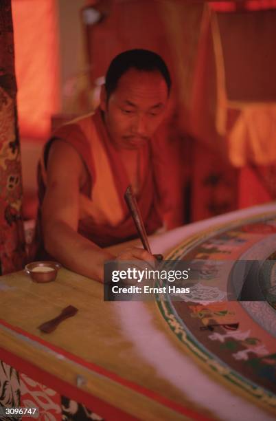 Buddhist monk tracing the Kalachakra mandala with coloured sand during the Kalachakra Initiation Ceremony in Bodhgaya in the state of Bihar in...