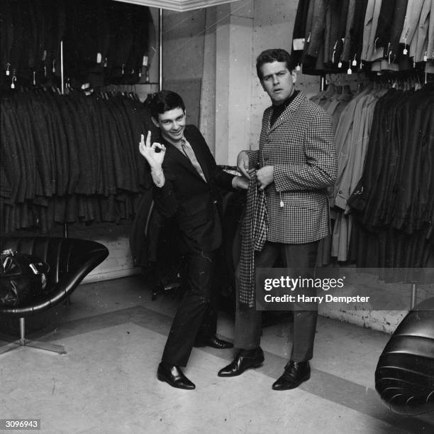 American pop singers Len Barry and Gene Pitney shopping together in a men's outfitters in London's Carnaby Street.