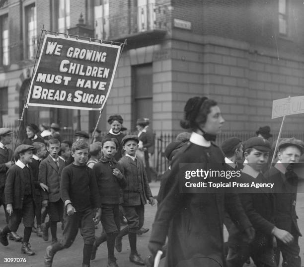 Children's rally in west London supporting prohibition. A banner they are carrying reads, 'We Growing Children Must Have Bread & Sugar'.
