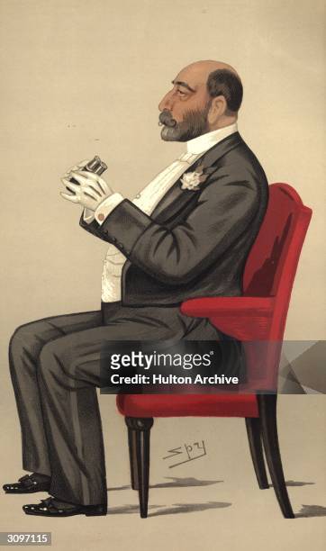 Banker and financier Reuben Sassoon prepares to look through a pair of opera glasses. Original Artwork: Lithograph by Vincent Brooks Day & Son for...
