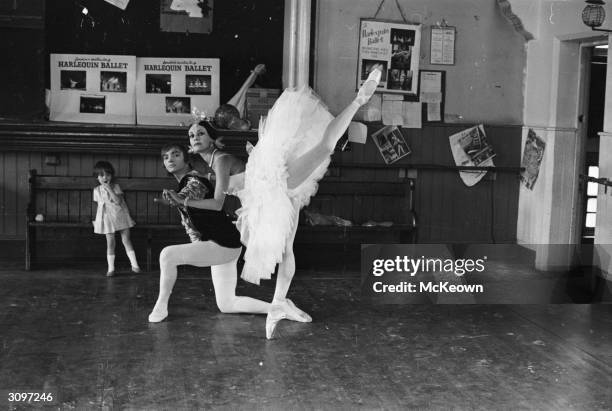 Ballet dancers Jelko Yuresha and Belinda Wright rehearse a pas de deux, watched by their daughter Annabel Lisa.