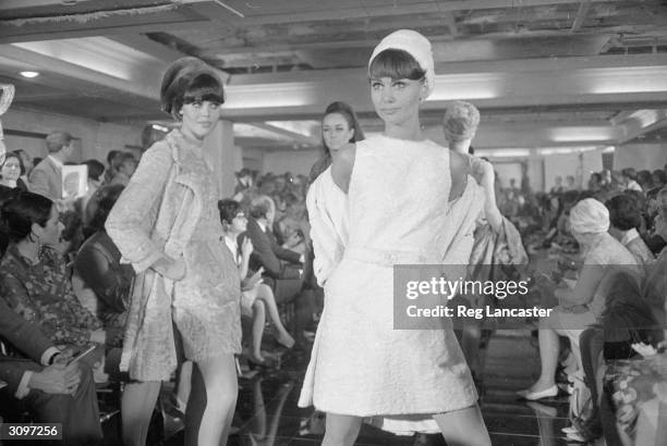 Models strut along the catwalk at a House of Dior fashion show.