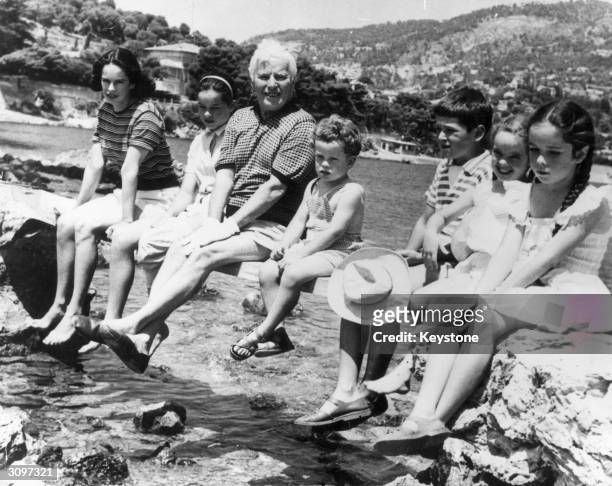 British born film actor, director and producer Charlie Chaplin on holiday in Saint Cap Ferrat with his family, his wife Oona and their children,...