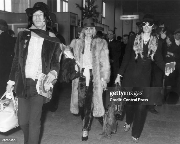 Rolling Stones lead singer Mick Jagger and the band's lead guitarist Keith Richards at London Airport with the German Actress Anita Pallenberg. The...