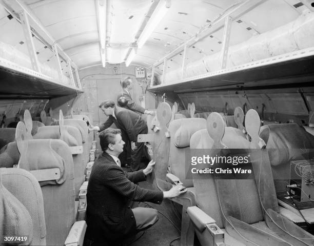 Team of designers examining a mock up of the interior of Concorde, April 1964.