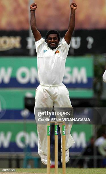 Sri Lankan off spinner Muttiah Muralitharan celebrates claming his 500th Test wicket during the first day of the second Test match between Australia...