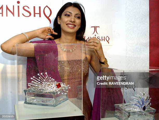 Former Miss World and actress Yukta Mookhey poses with the winners crowns of the Ponds Femina Miss India Earth Contest 2004, during their unveiling...