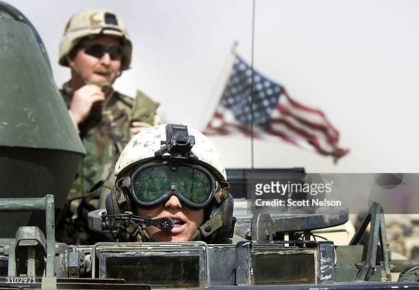 Army 3rd Infantry Task Force 3-7 soldiers ride atop an armored vehicle during a training exercise near the Iraqi border March 13, 2003 in northern...