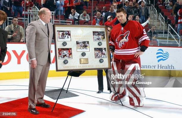 Goalie Brian Boucher of the Phoenix Coyotes is given an award honoring his five consecutive shut-outs, prior to the game against the Calgary Flames...