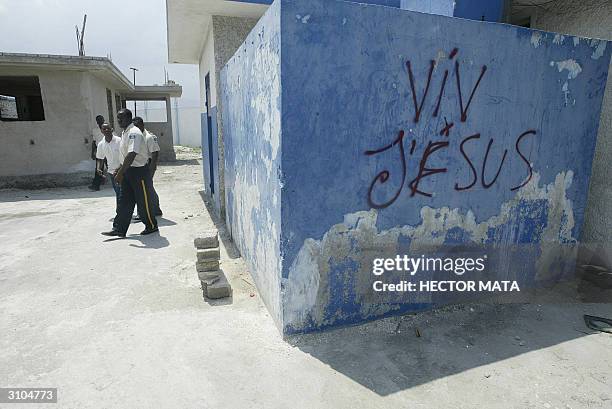 Members of Haitian Police re-enter a Police Station destroyed during the recent unrest leading up to and following the departure of ex-president...