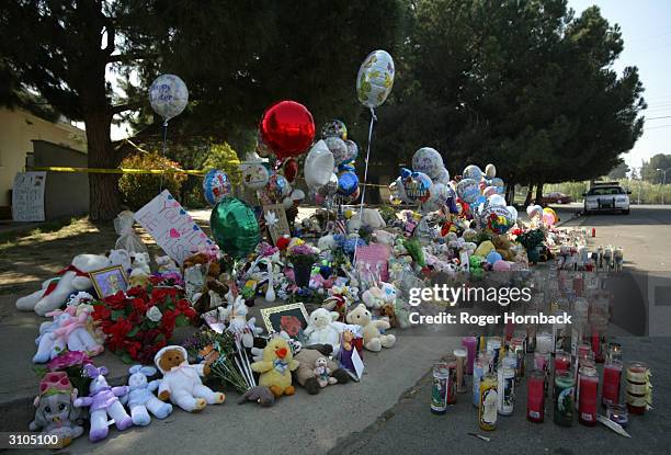 Makeshift memorial to the nine victims found shot to death in front of of the house where accused killer Marcus Wesson lived is shown March 17, 2004...