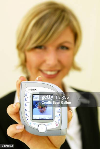 Model holds the new Nokia 7600 mobile phone at the CeBIT technology trade fair March 18, 2004 in Hanover, Germany. The 7600 is both UMTS and GMS...