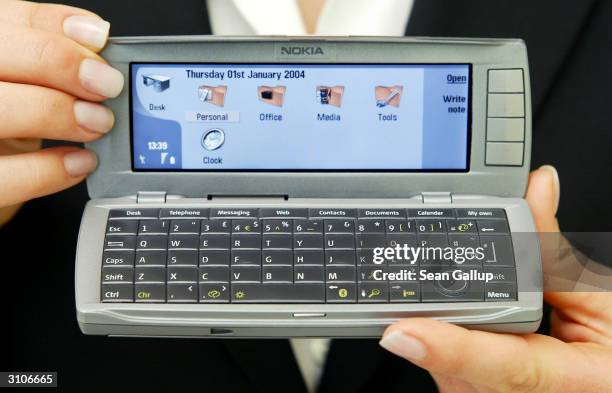 Model holds the new Nokia Communicator 9500 mobile phone at the CeBIT technology trade fair March 18, 2004 in Hanover, Germany. The 9500 is wifi, or...