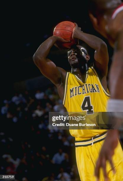 Chris Webber of the Michigan Wolverines moves the ball during a game against the Ohio State Buckeyes. Mandatory Credit: Duane Burleson /Allsport